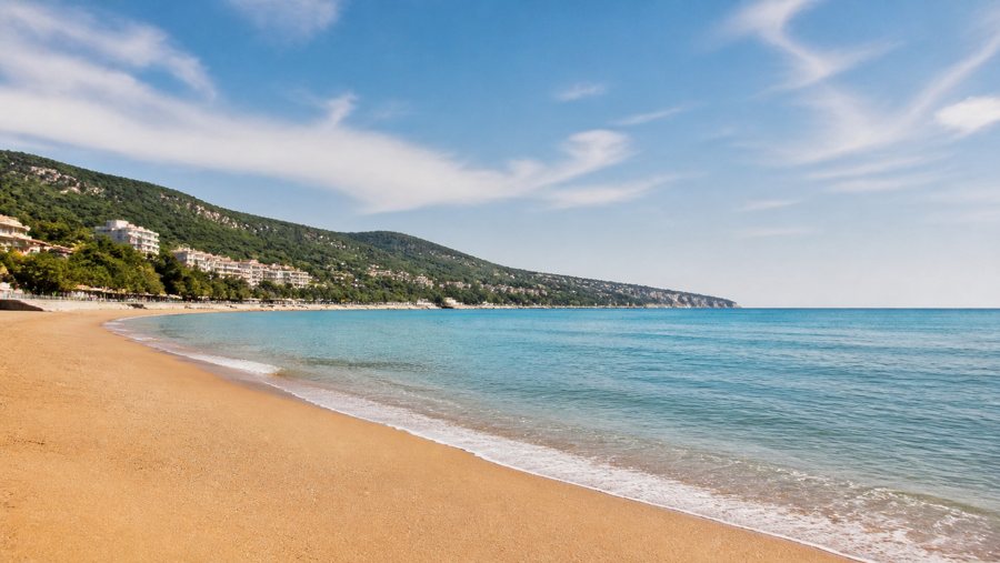 AI-generated illustration of a sandy beach, calm sea and wooded hillside